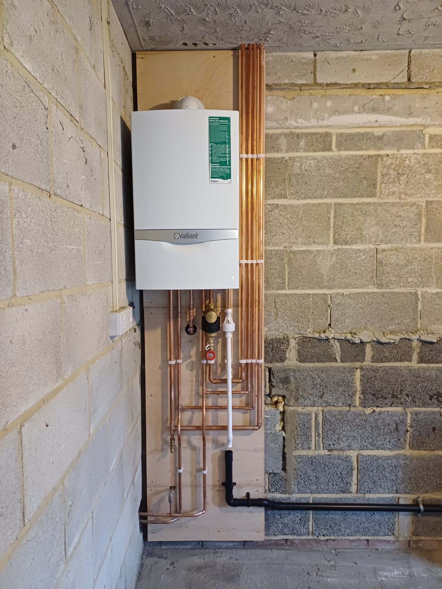 Sugden's boiler installation with neatly arranged copper pipework