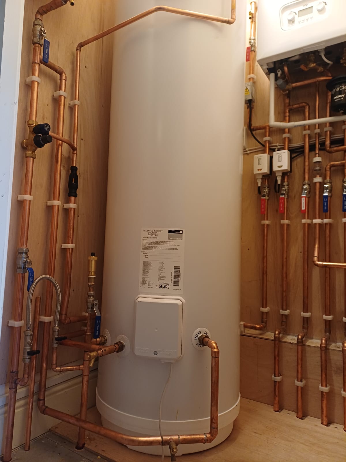Hot-water cylinder with copper pipework and valves