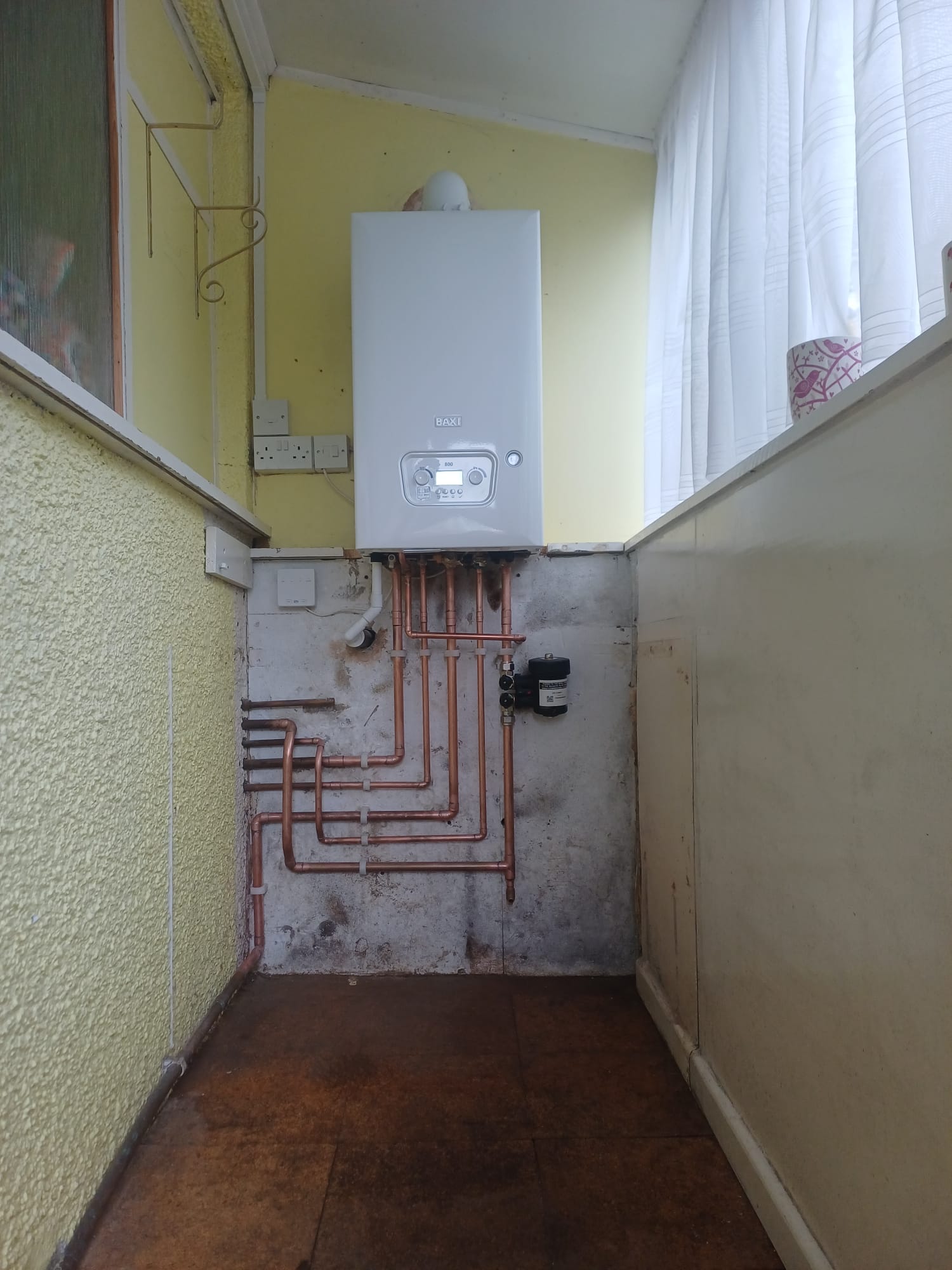 Wall-mounted boiler and carefully routed copper pipework